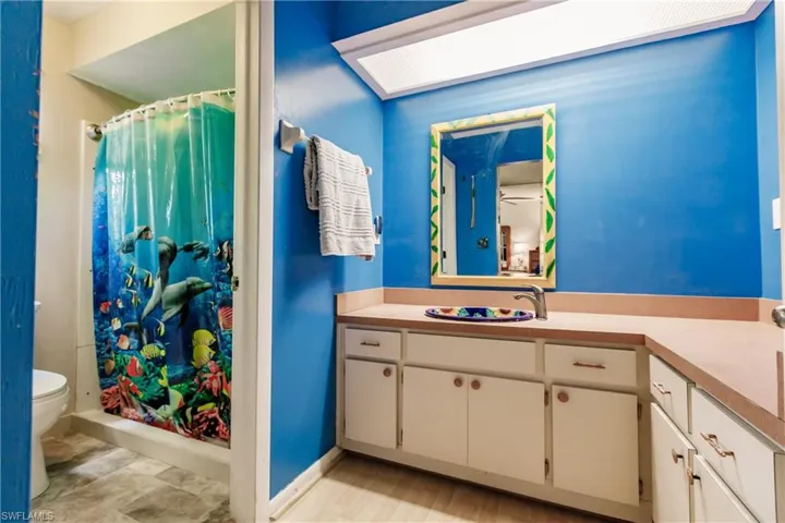 Bathroom featuring vanity, tile patterned flooring, and toilet