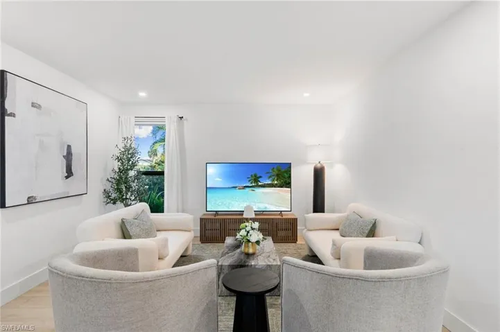 Living area featuring light wood-type flooring, recessed lighting, and baseboards