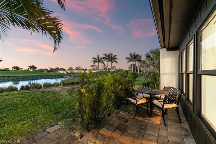 View of patio with outdoor dining area and a water view