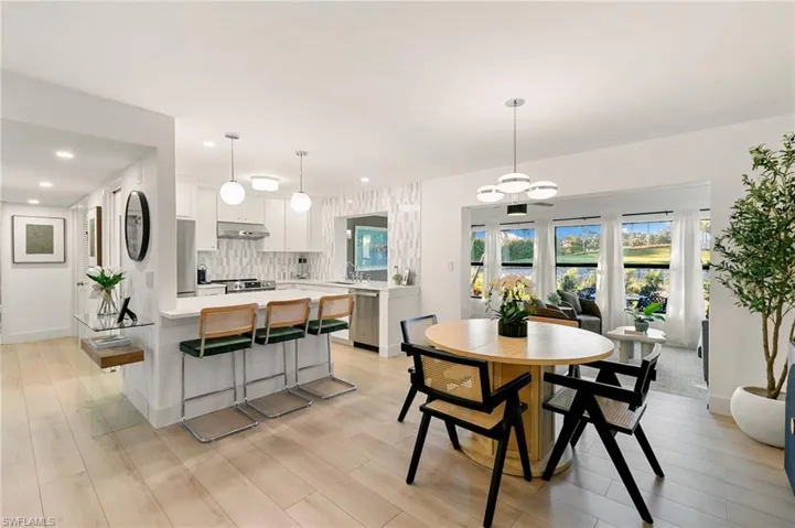 Dining area featuring light wood finished floors, baseboards, and recessed lighting