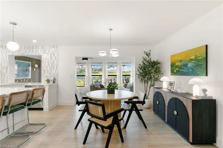 Dining area featuring light wood-style flooring and baseboards