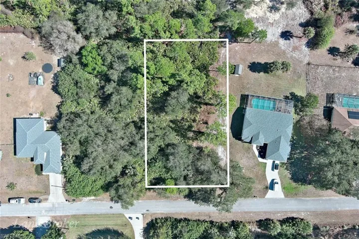 Aerial view of property and surrounding area with property parcel outlined