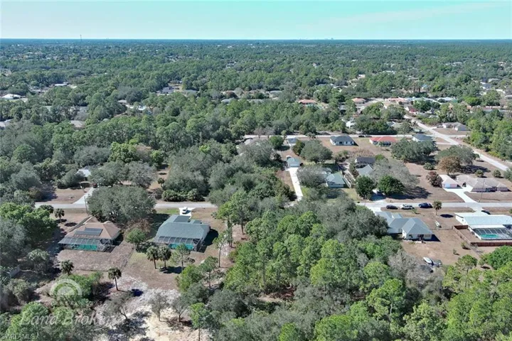 Aerial view of property and surrounding area featuring a heavily wooded area