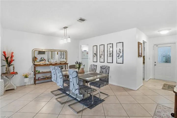 Dining space featuring light tile patterned floors and a textured ceiling