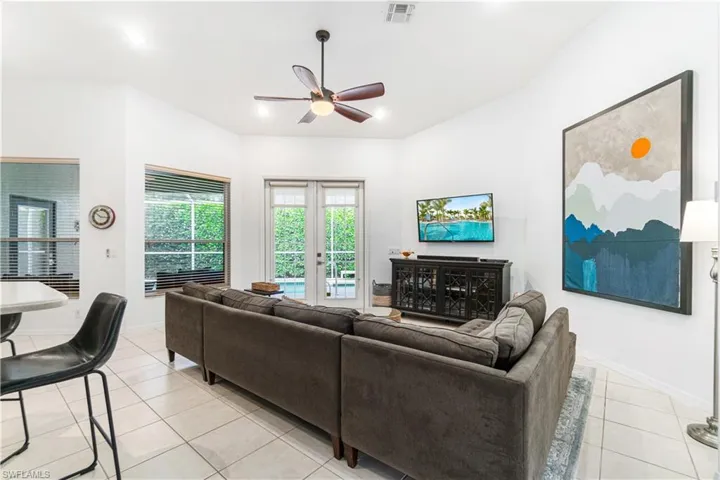 Living room with soaring ceilings and access to the pool deck