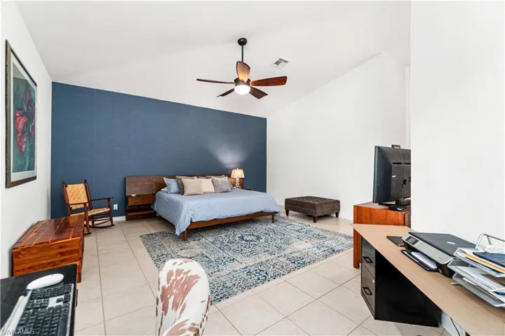 Oversized primary suite with office area/sitting nook & huge walk-in closet with custom shelving.