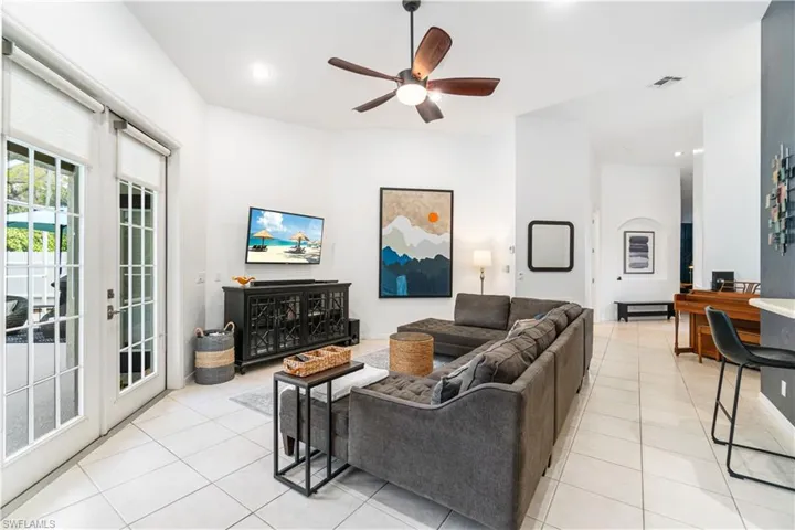 Living room with soaring ceilings and access to the pool deck