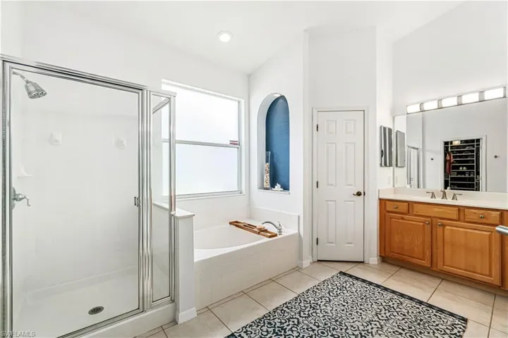 Oversized en-suite bath with large tub, walk-in shower, dual vanities & separate water closet