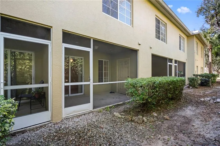 Rear view of house with a sunroom and stucco siding