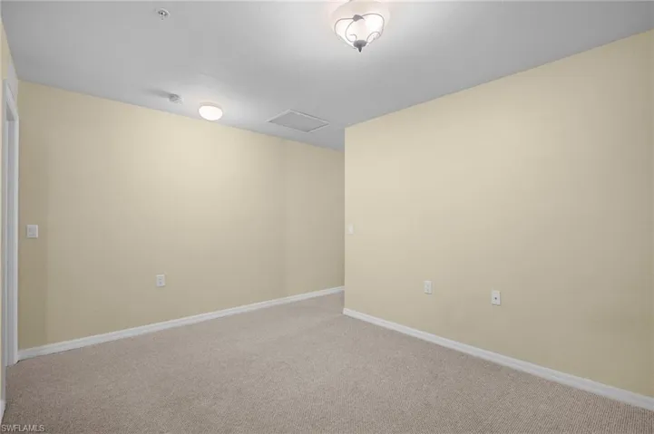 Carpeted spare room with baseboards