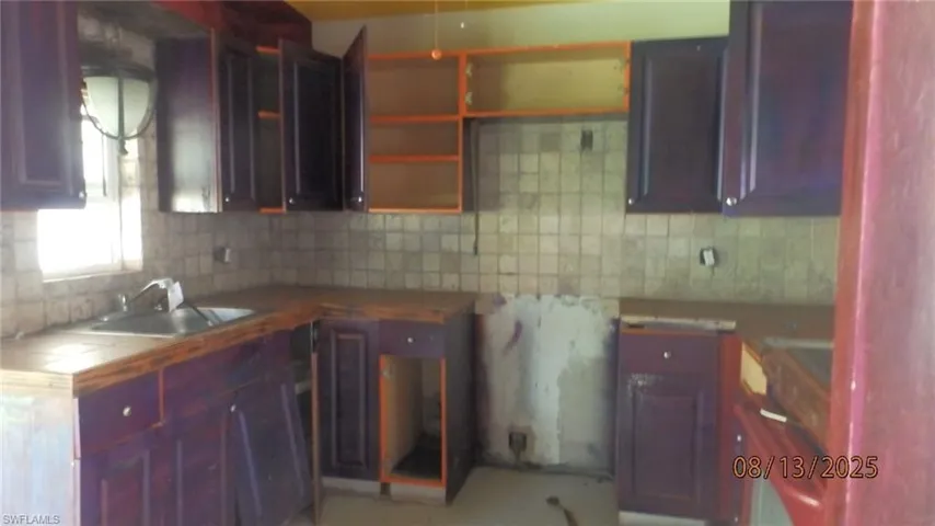 Kitchen with backsplash and tile counters