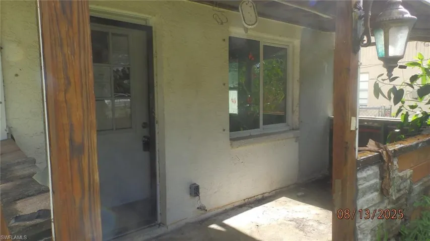 Entrance to property featuring stucco siding