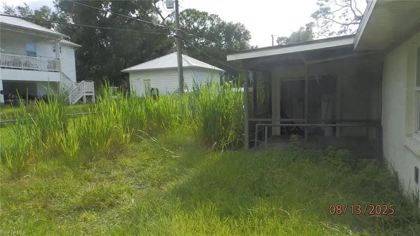 View of yard featuring a sunroom
