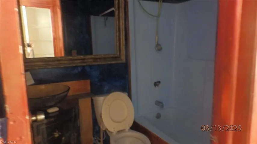 Full bathroom featuring shower / washtub combination and toilet