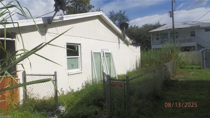 View of side of home with stucco siding