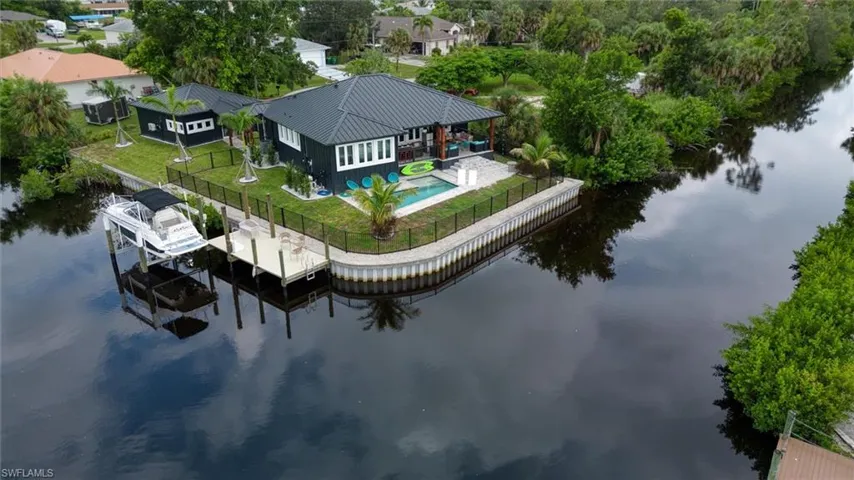 Waterfront property featuring a private boat lift and an expansive dock