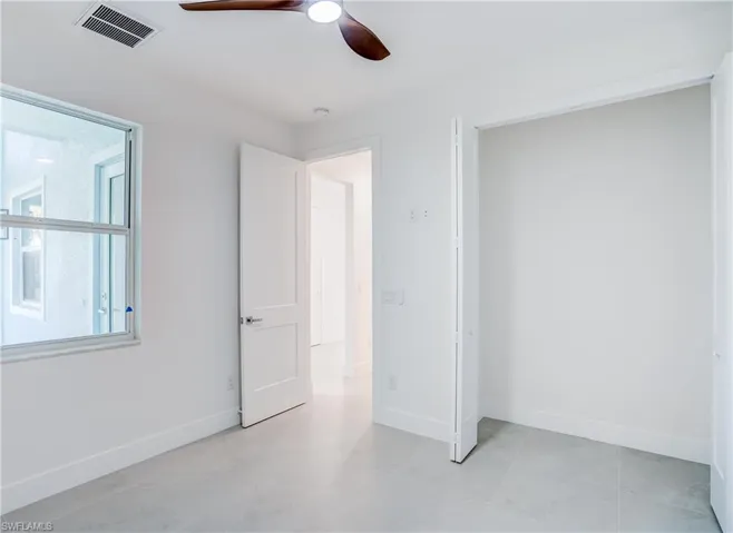 Unfurnished bedroom featuring baseboards and a ceiling fan