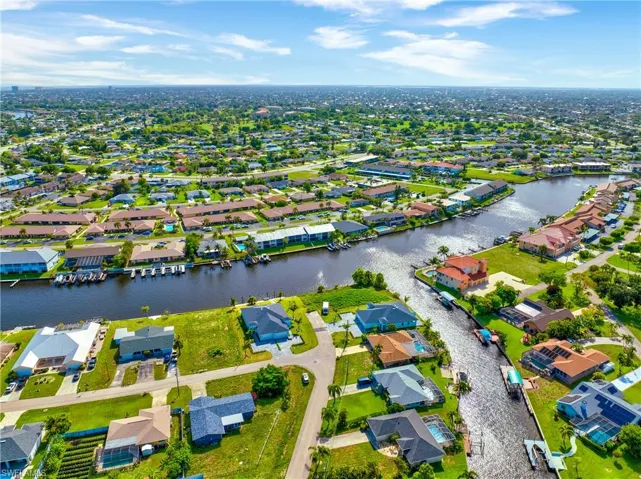 Aerial view of residential area featuring a nearby body of water