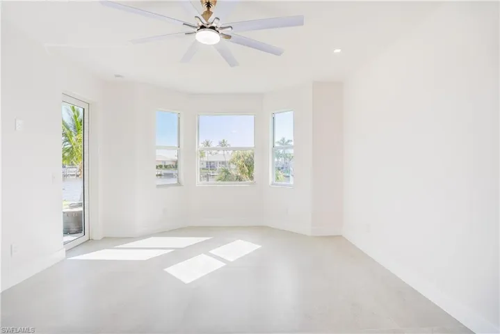 Empty room featuring ceiling fan and recessed lighting