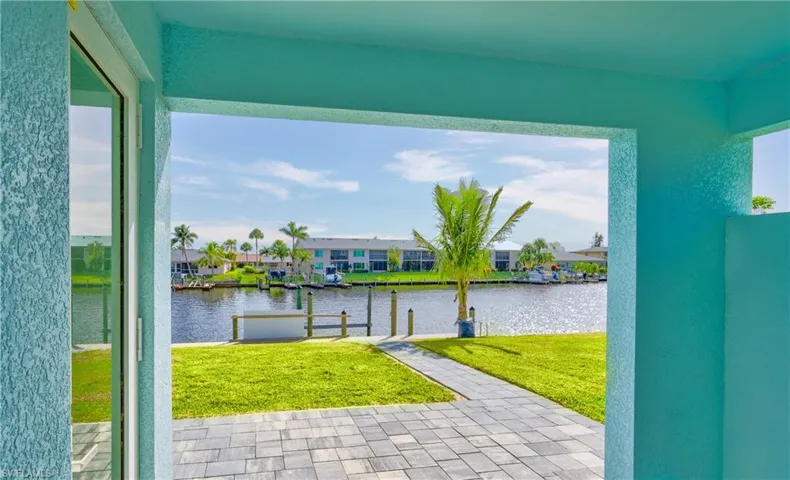 View of patio / terrace with a water view, a residential view, and a dock