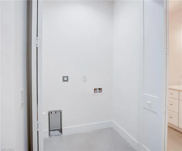 Washroom with hookup for an electric dryer and hookup for a washing machine