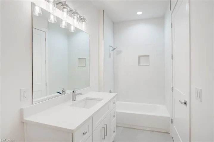 Full bath with vanity, bathing tub / shower combination, tile patterned flooring, and recessed lighting
