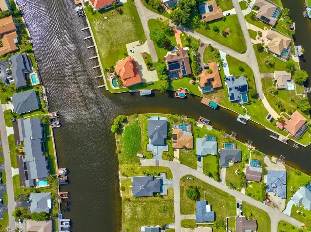 Aerial view of property and surrounding area with nearby suburban area