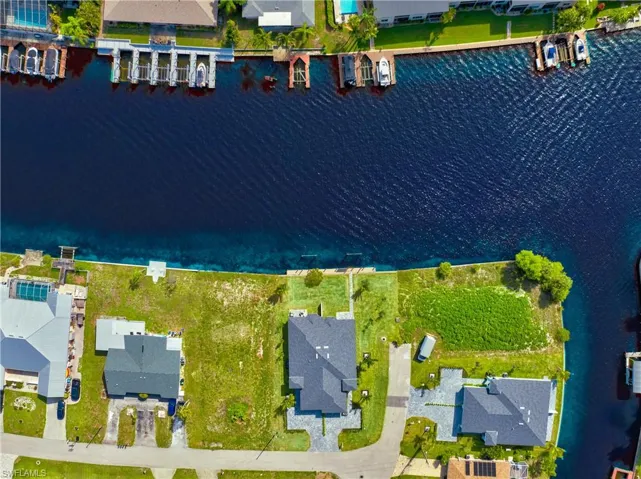 Aerial perspective of suburban area featuring a large body of water
