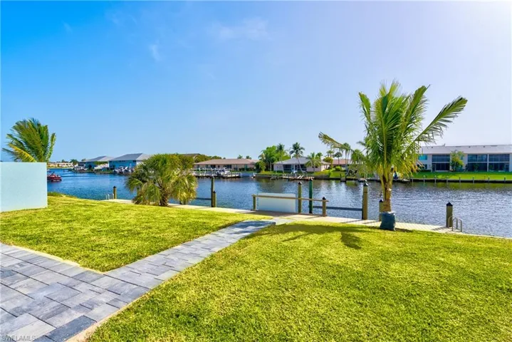 Dock area featuring a residential view, a yard, and a water view
