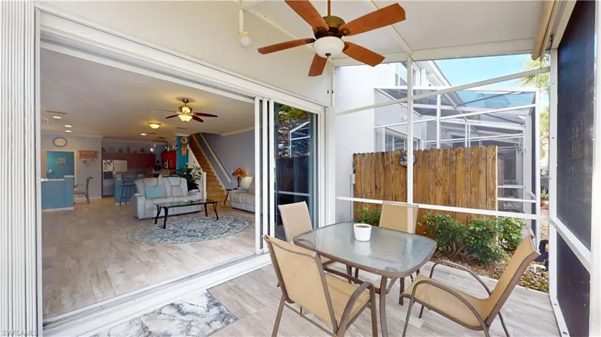 Sunroom with a wealth of natural light and ceiling fan