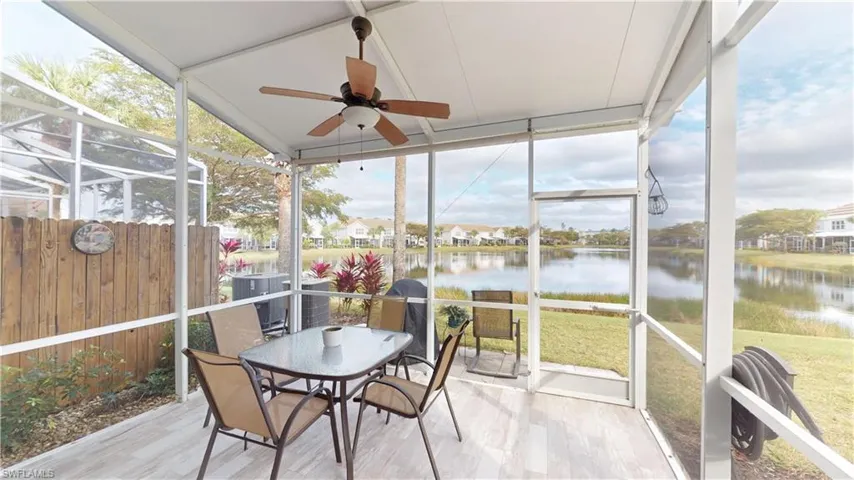 Sunroom / solarium featuring plenty of natural light, a water view, and ceiling fan