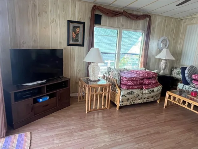 Bedroom featuring wood walls and hardwood / wood-style flooring