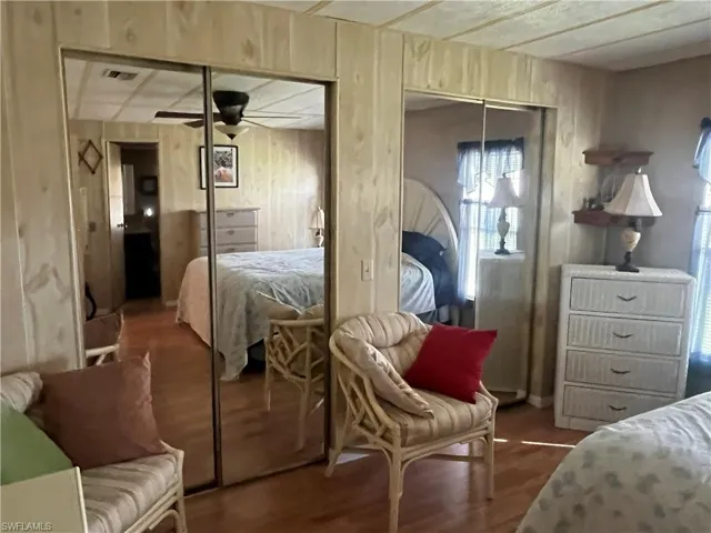 Bedroom featuring wood-type flooring, ceiling fan, and a closet