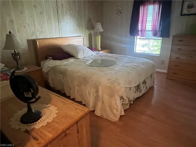 Bedroom with hardwood / wood-style floors