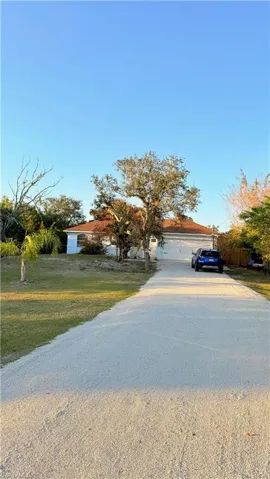 View of front of home featuring concrete driveway and an attached garage