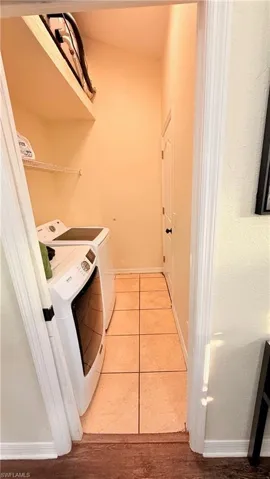 Laundry room featuring light tile patterned floors and washer and dryer