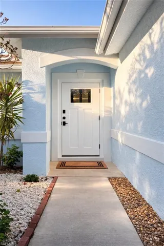 View of exterior entry with stucco siding