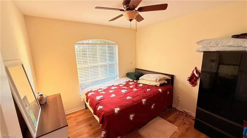 Bedroom with wood finished floors and a ceiling fan