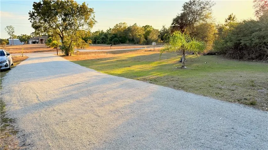 View of road with view of wooded area