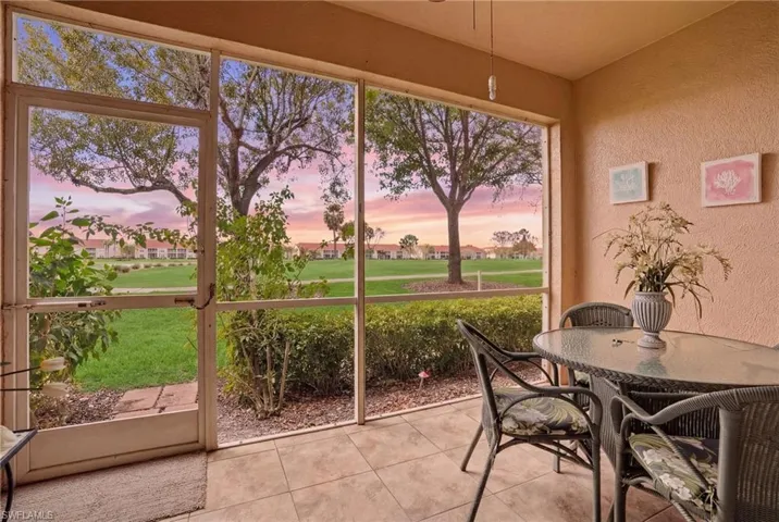 Sunroom / solarium featuring a residential view and view of golf course