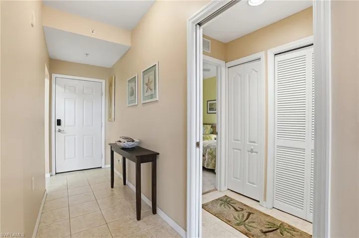 Entrance foyer featuring light tile patterned flooring and baseboards