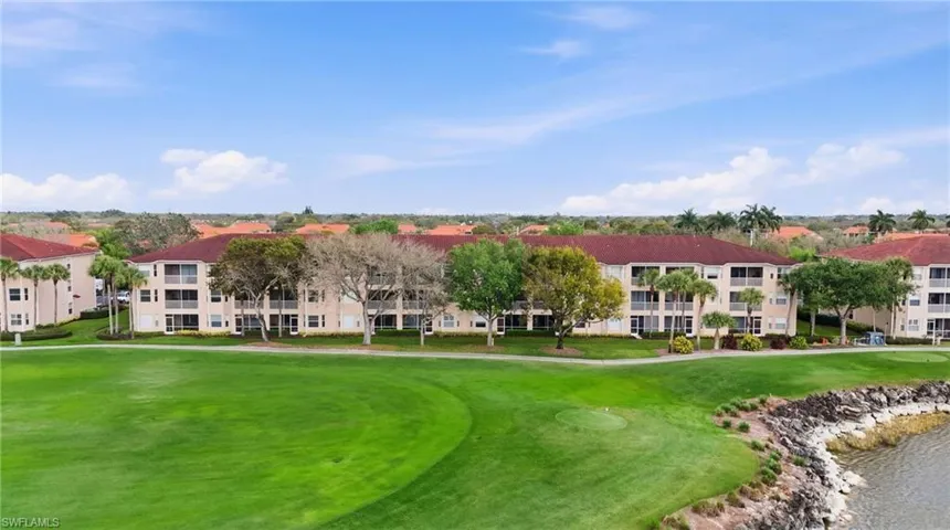 View of home's community with view of golf course and a water view