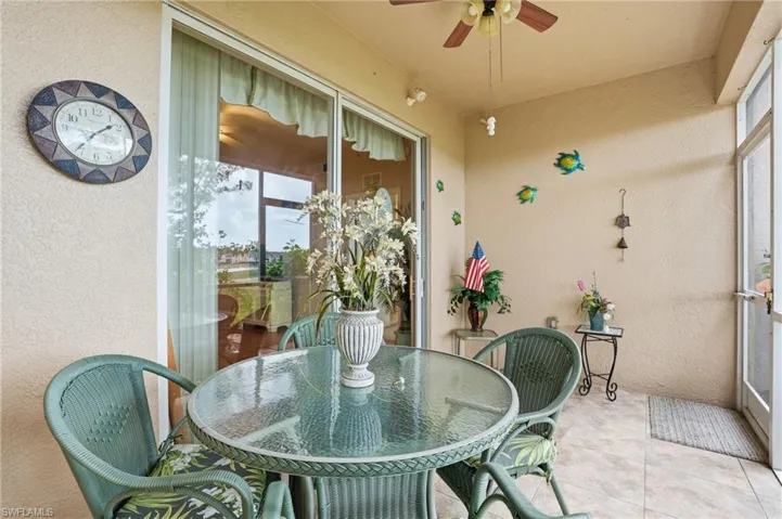 Sunroom / solarium featuring outdoor dining space and a ceiling fan