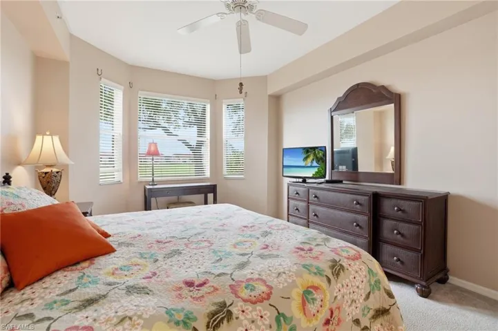 Bedroom featuring a ceiling fan and light colored carpet