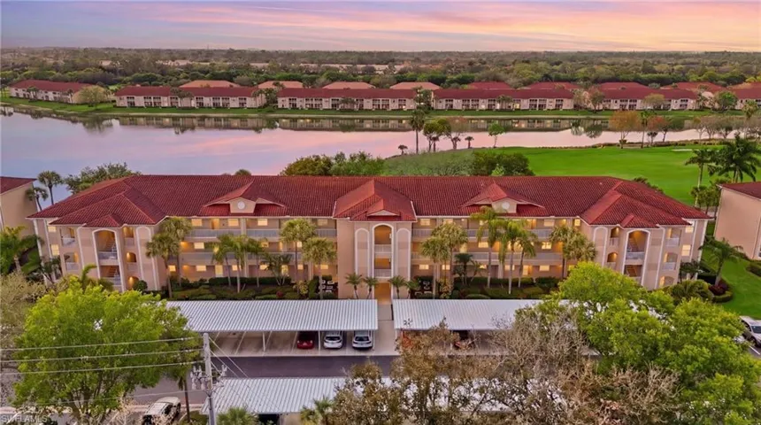 Drone / aerial view of apartment complex / building and a nearby body of water