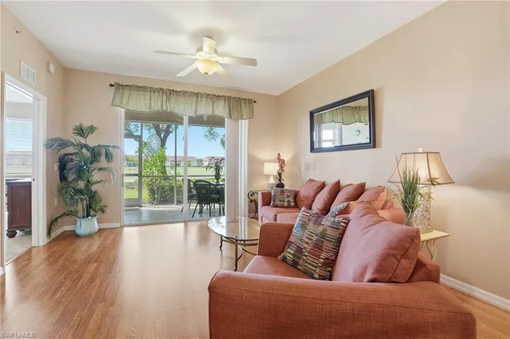 Living area featuring a ceiling fan and light wood-type flooring