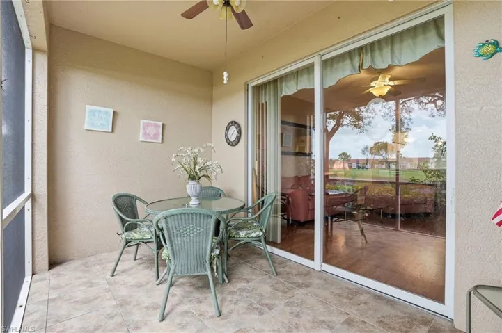 Sunroom with ceiling fan and outdoor dining area