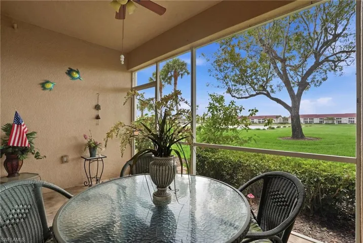 Sunroom featuring outdoor dining area and ceiling fan