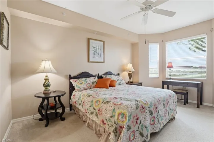 Bedroom featuring light colored carpet and a ceiling fan