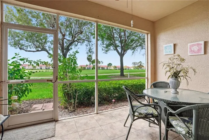 Sunroom / solarium featuring outdoor dining area and golf course view